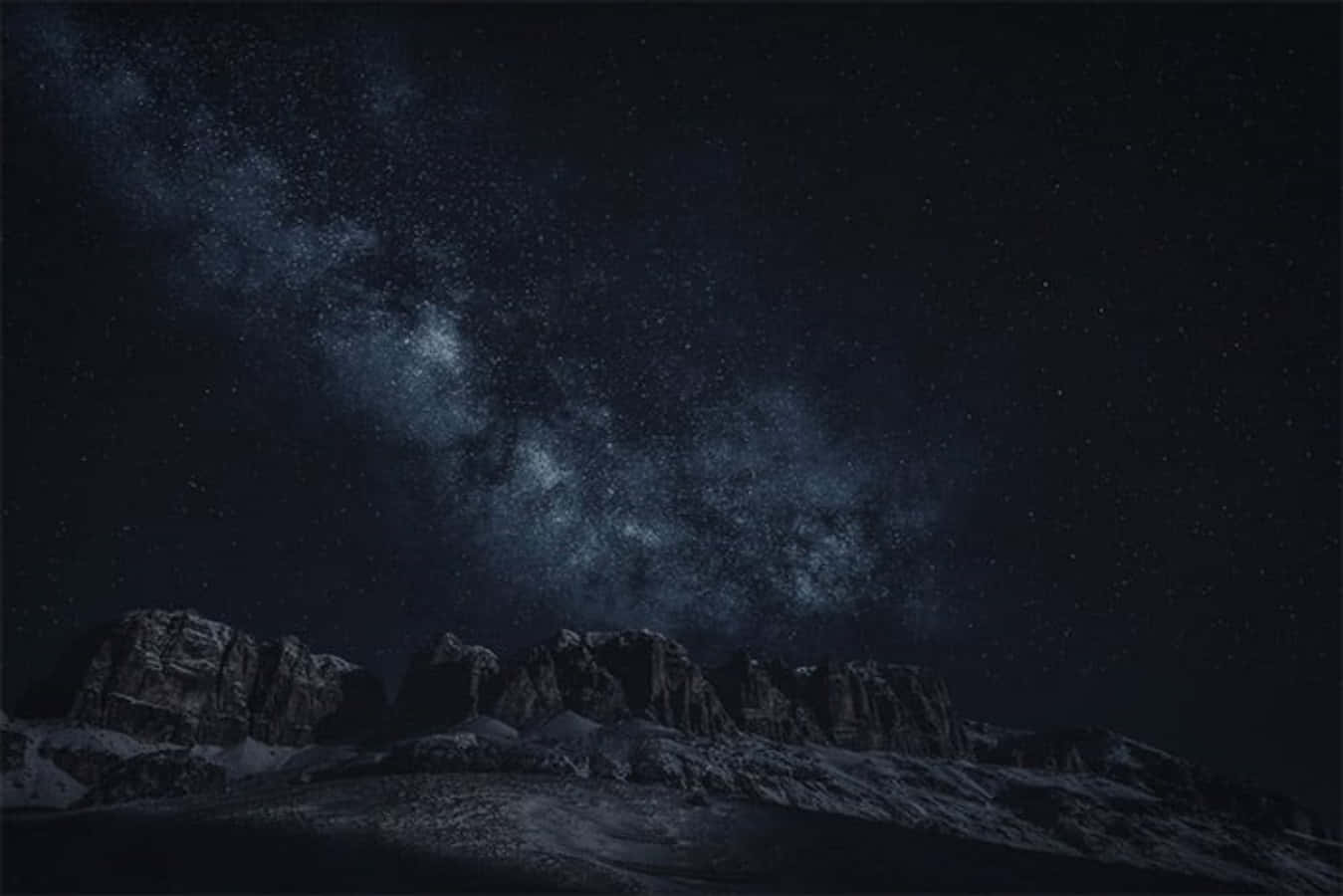 A Mountain Range With Snow And Stars In The Sky Background