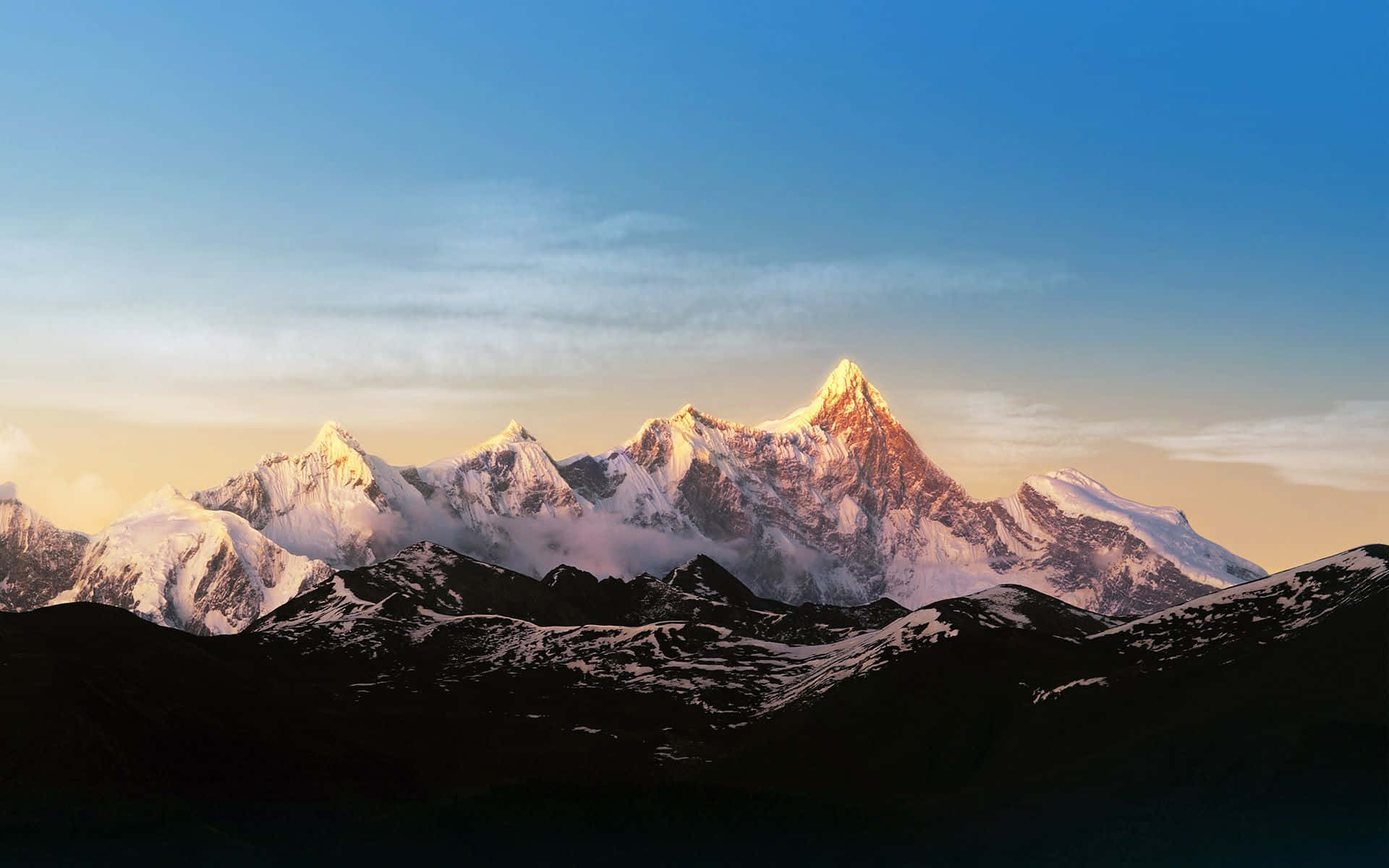 A Mountain Range With Snow Capped Mountains In The Background Background