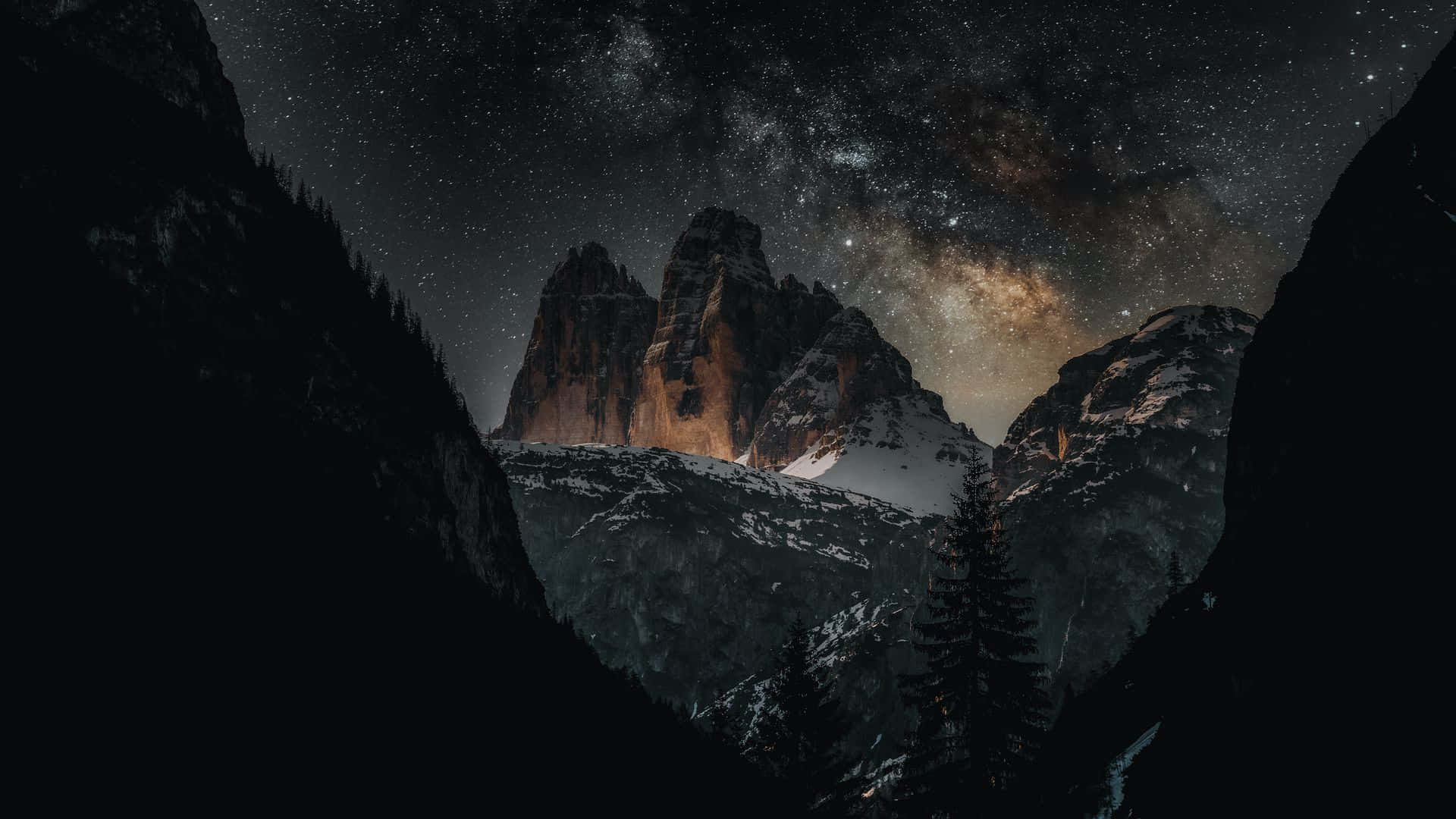 A Mountain Range With Stars And Milky Background