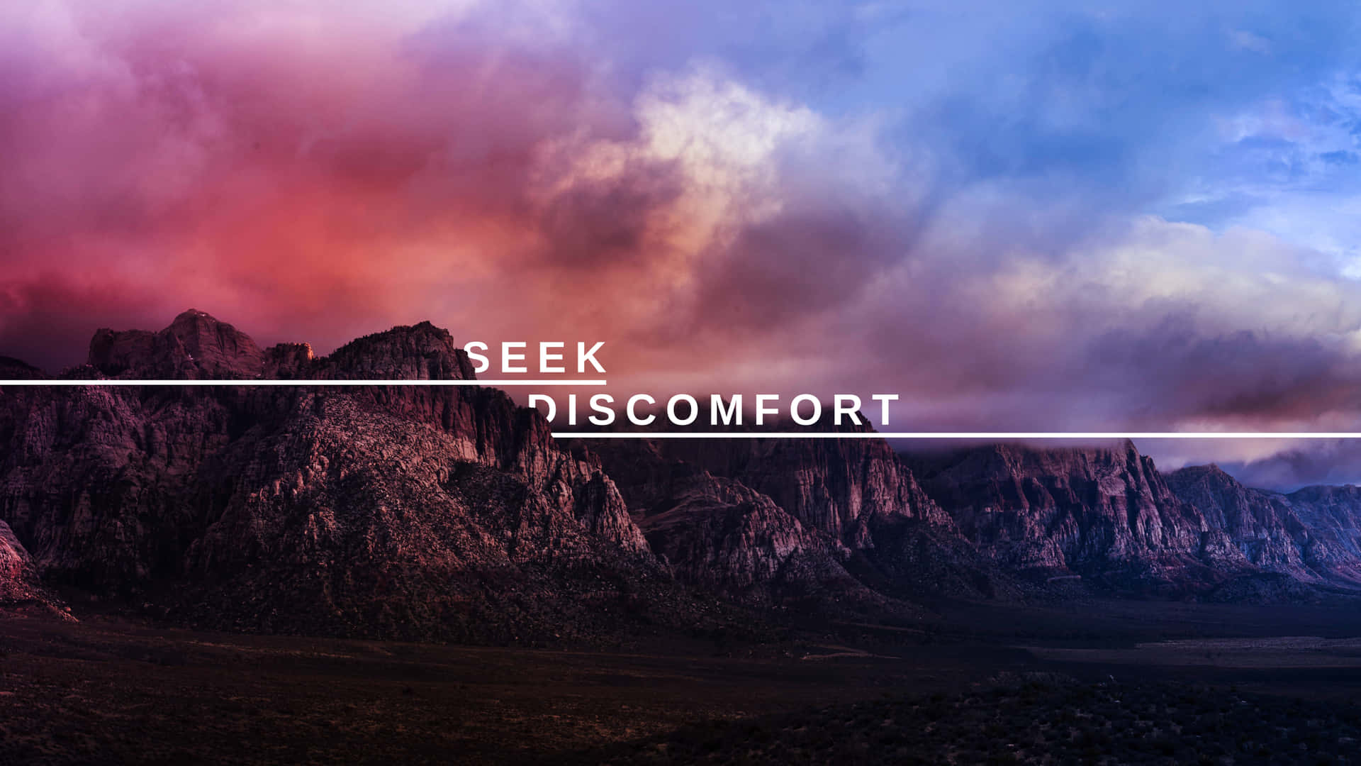 A Mountain Range With The Words Seek Discomfort Background