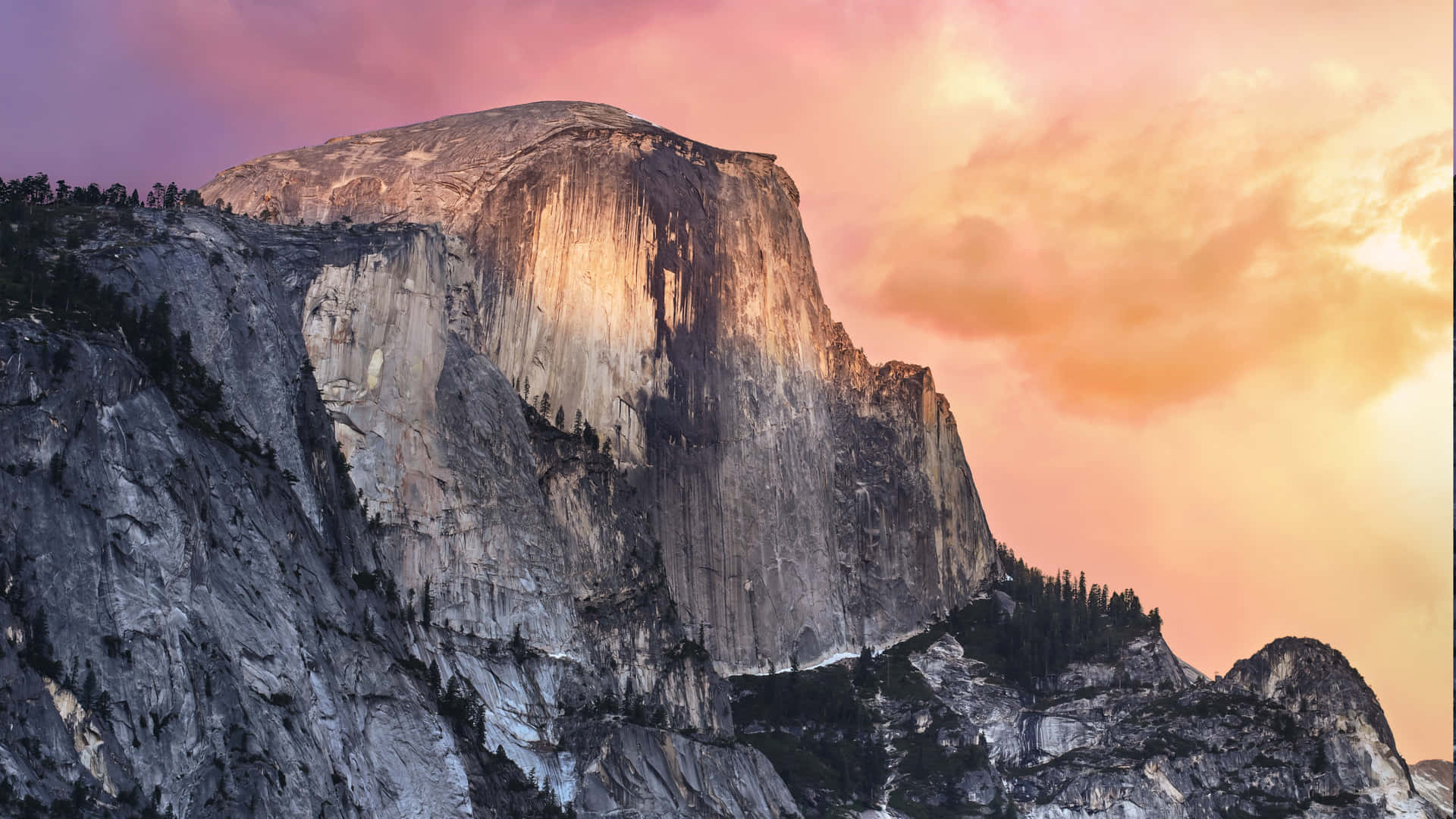 A Mountain With A Colorful Sunset Behind It Background