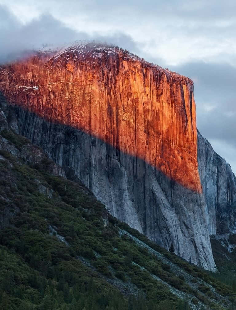 A Mountain With A Red Light Shining On It Background