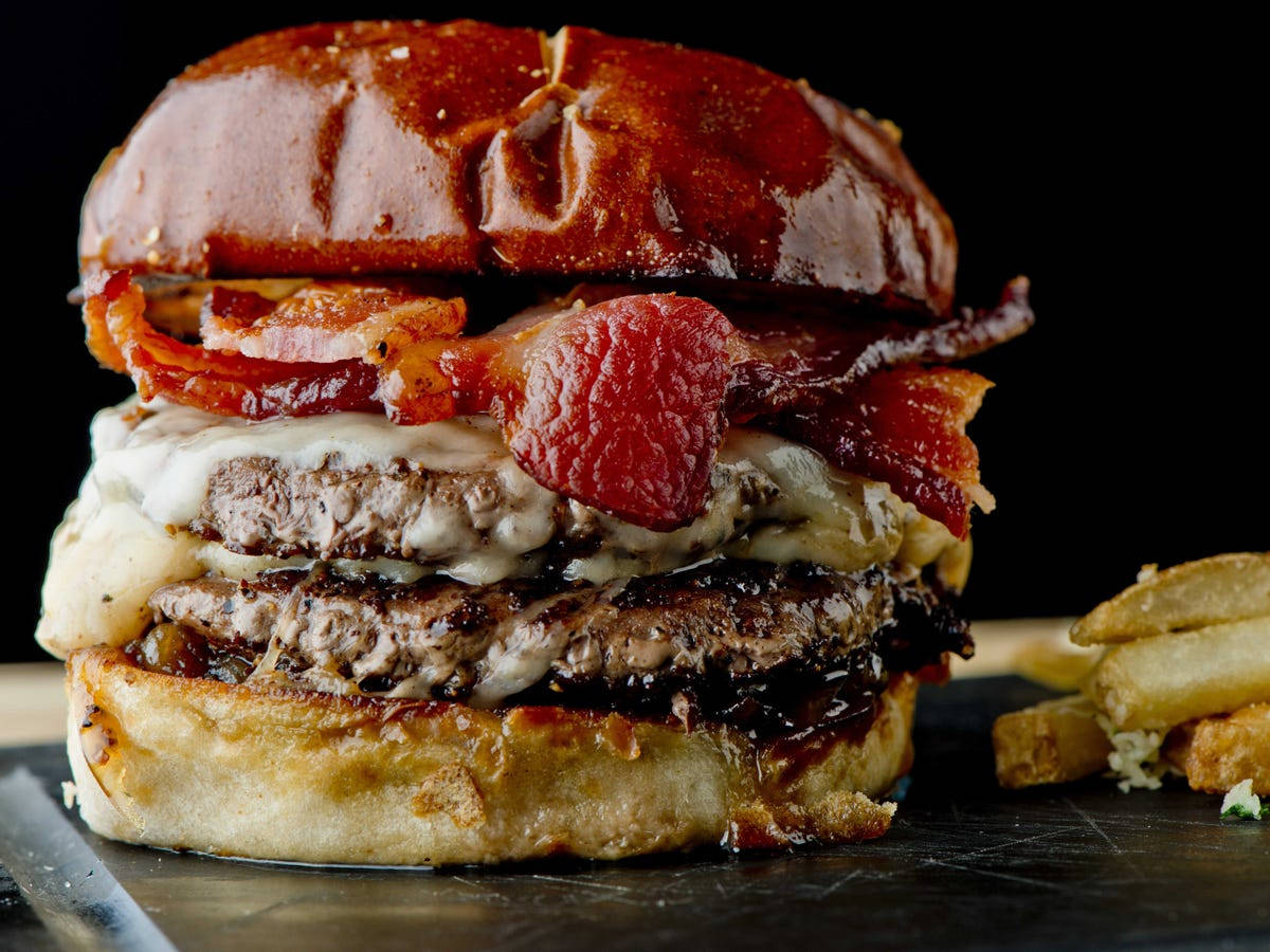 A Mouth-watering Burger Topped With Crispy Sheesh Bacon. Background