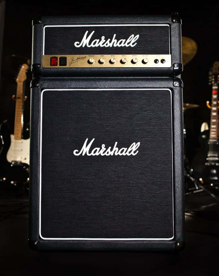 A Musician Plays An Electric Guitar With A Classic Tube Amplifier Background