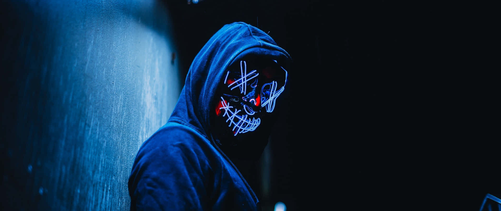 A Mysterious Dark Desktop With Glow Outlined Objects Background