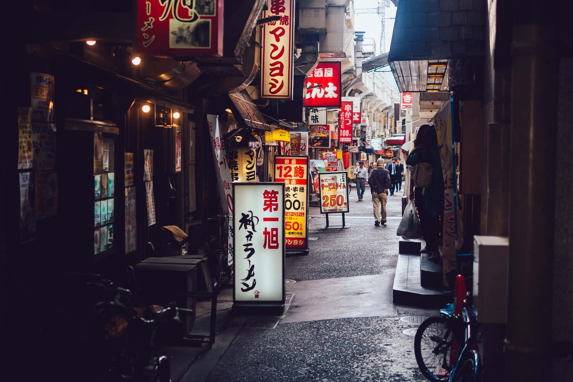 A Narrow Alleyway With A Lot Of Signs Background