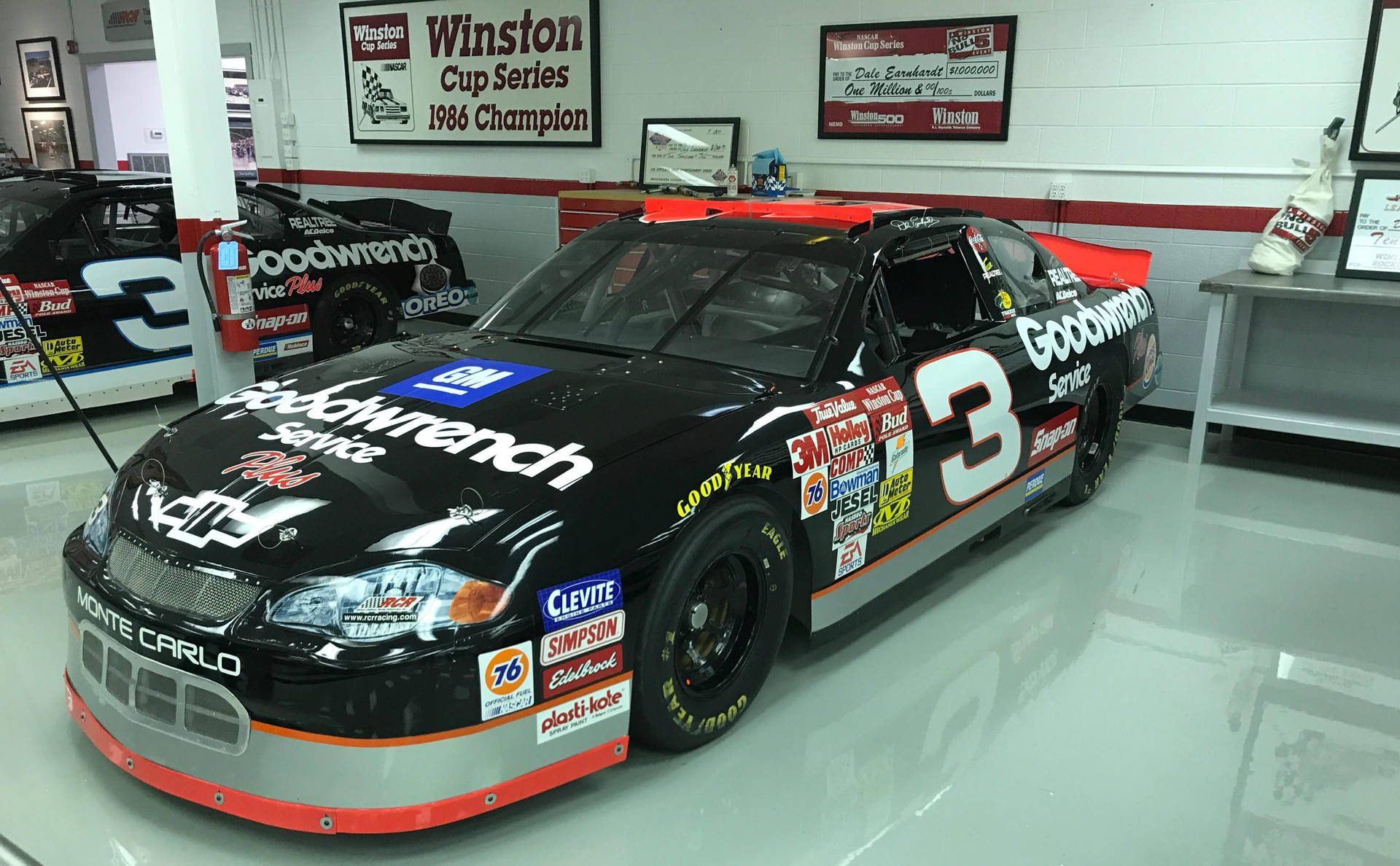 A Nascar Car Is Parked In A Garage