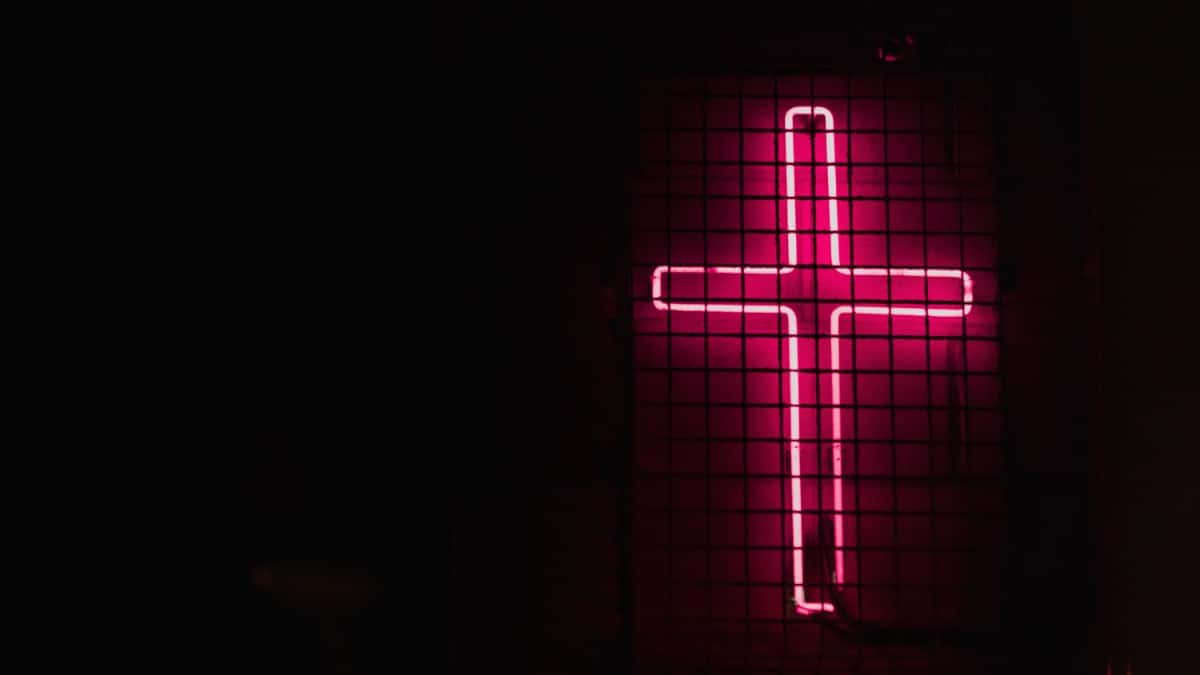 A Neon Cross Creates A Mystical Scene Of Faith Background