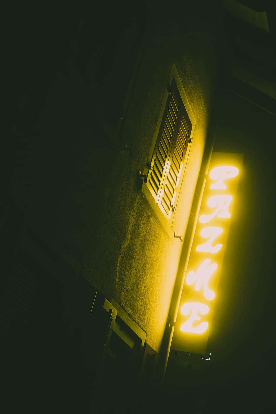 A Neon Sign On A Building Background