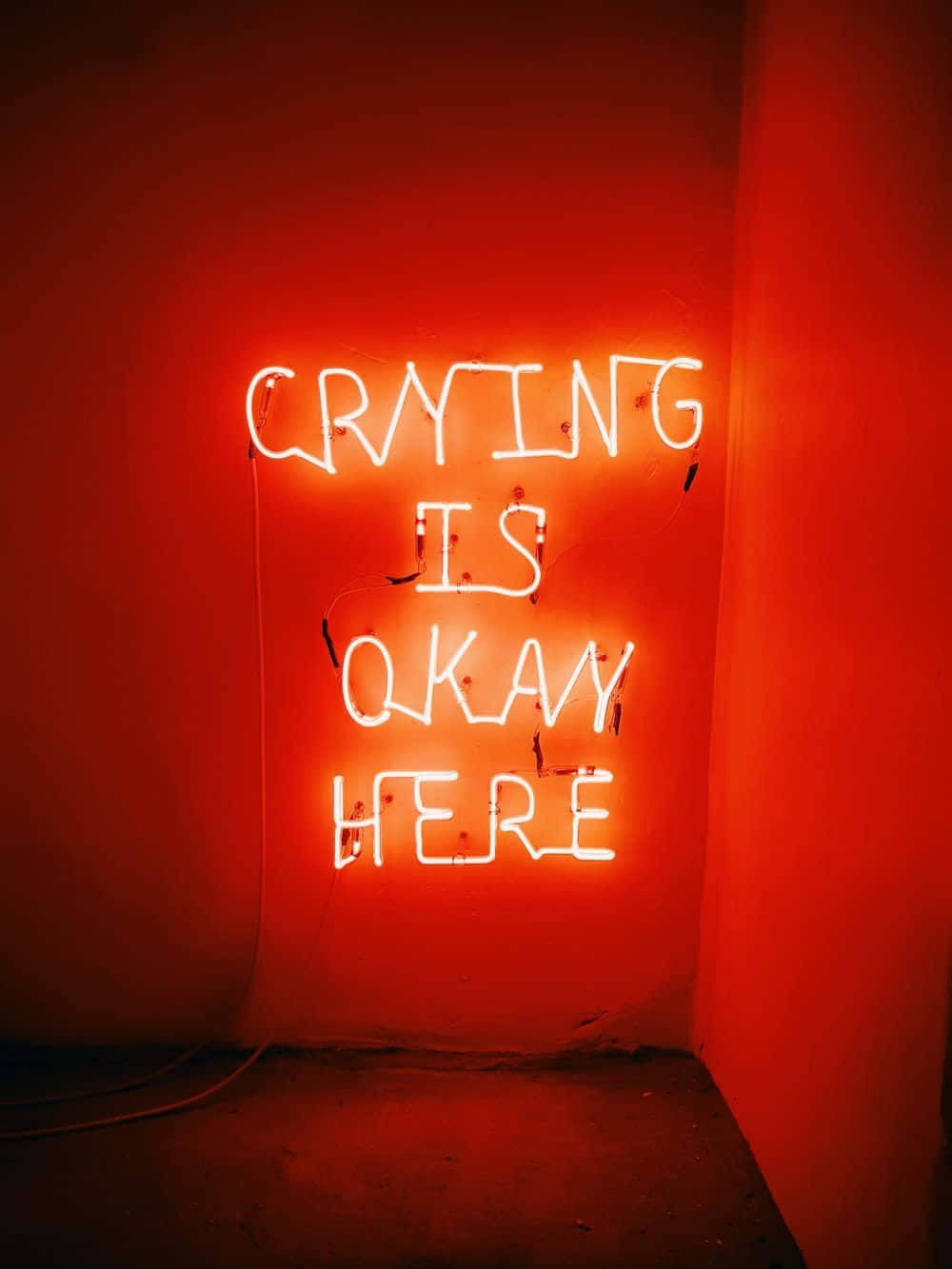 A Neon Sign That Says Crying Is Okay Here Background