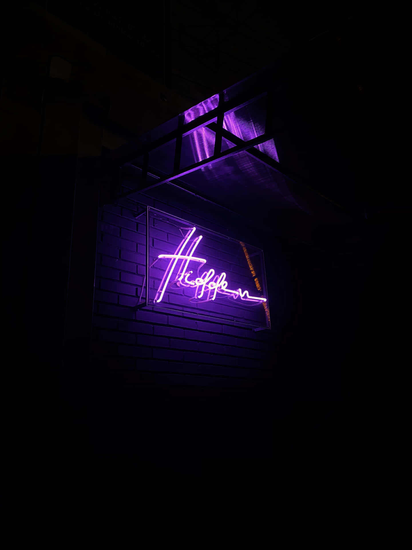 A Neon Sign With A Purple Light Background