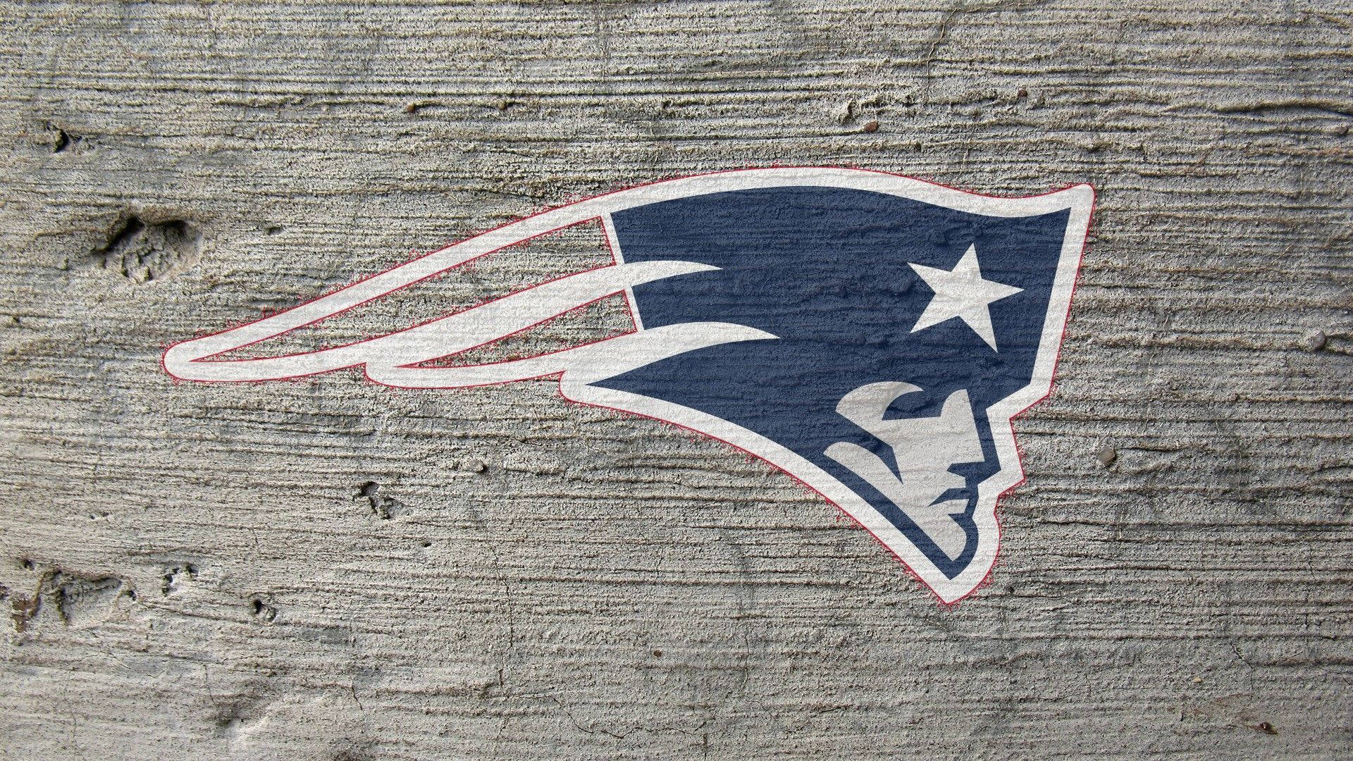 A New England Patriots Sticker On A Concrete Wall Background