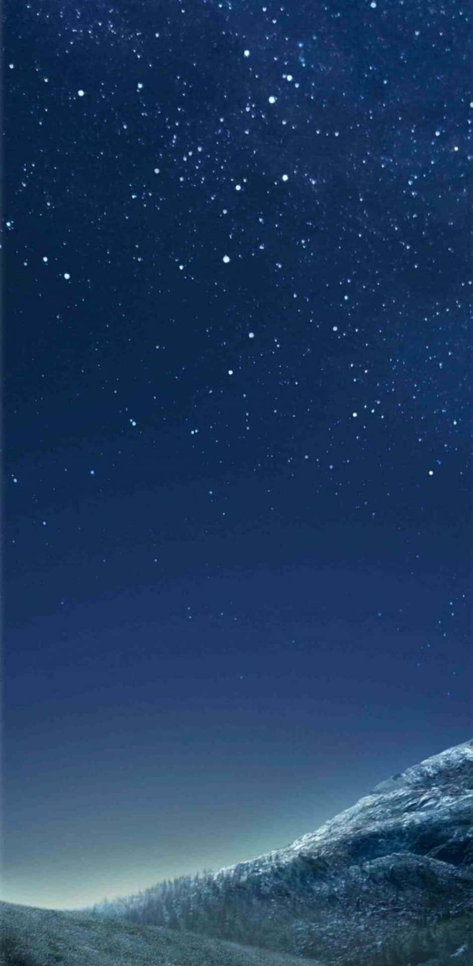 A Night Sky With Stars And A Mountain Background