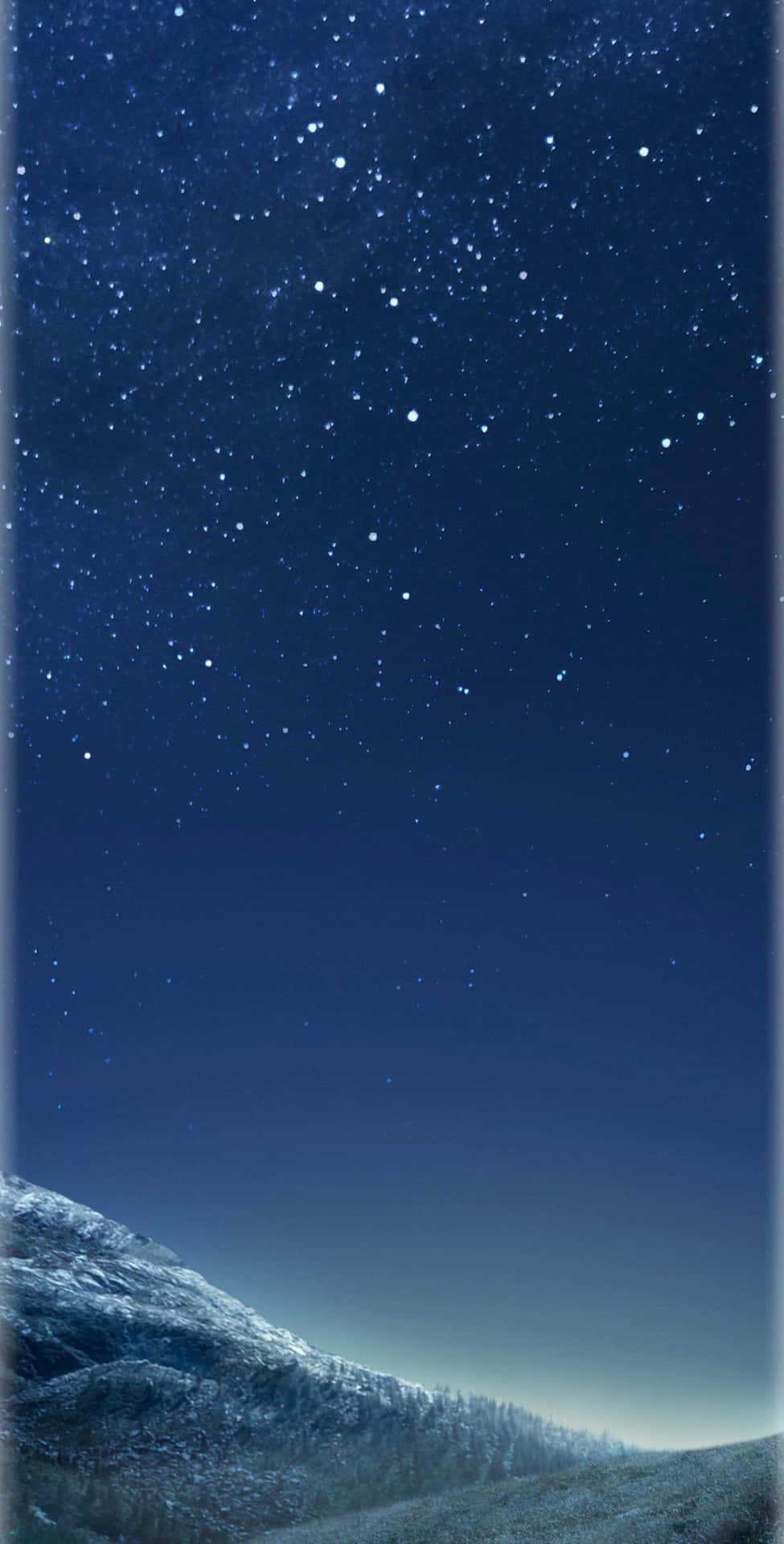 A Night Sky With Stars And A Mountain Background