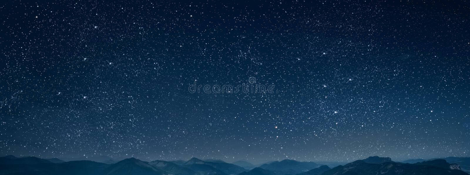 A Nighttime View Of The Majestic Mountains Background