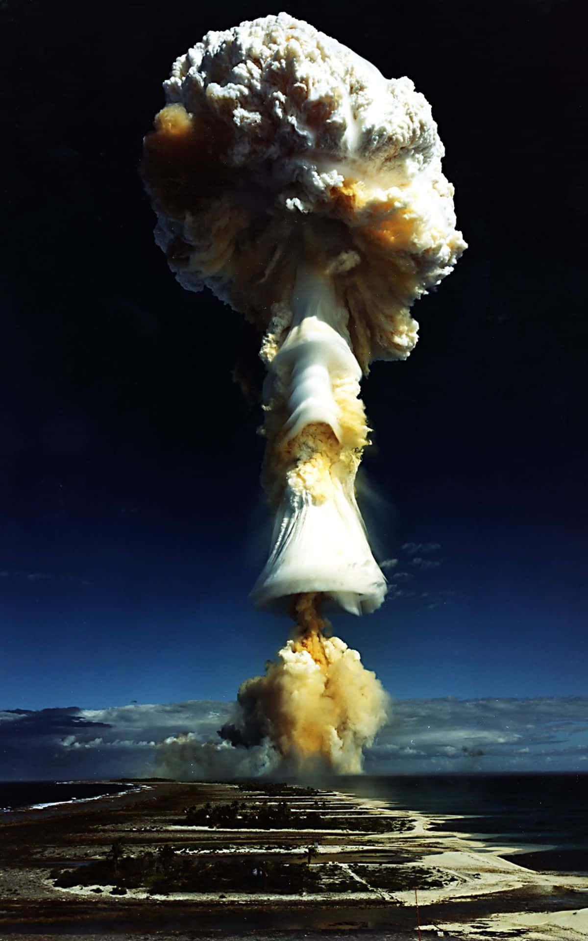A Nuclear Explosion Is Seen Over A Beach Background