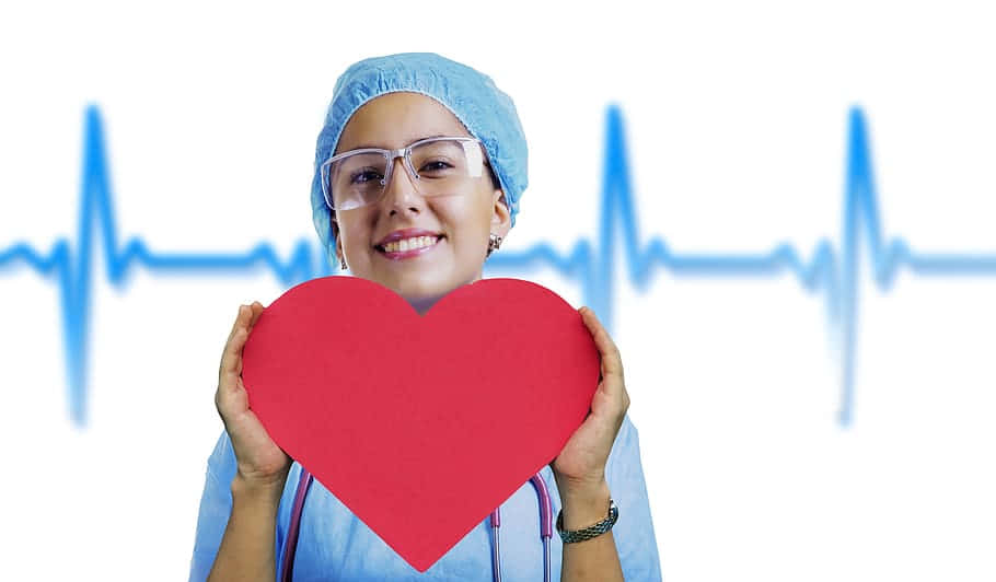 A Nurse Holding A Heart With An Ecg Background