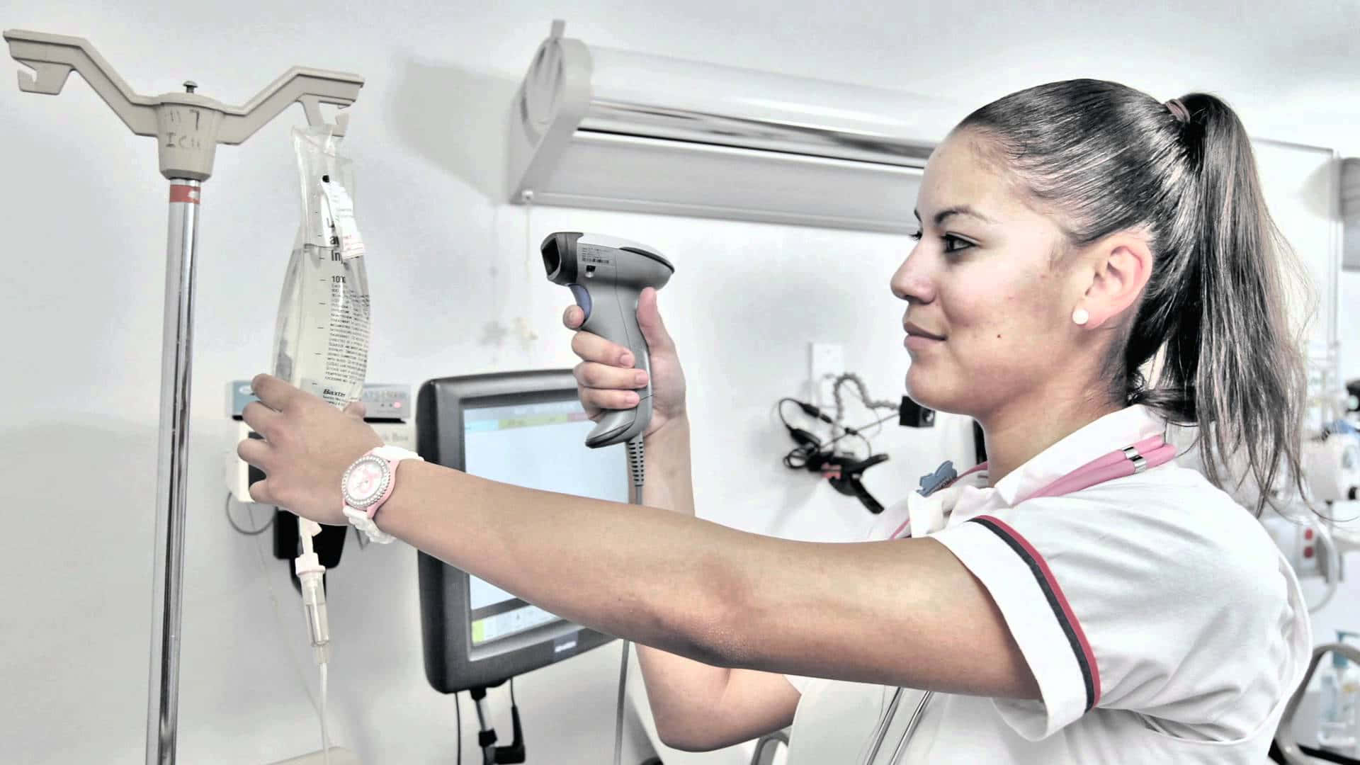 A Nurse Is Using A Device To Check A Patient Background