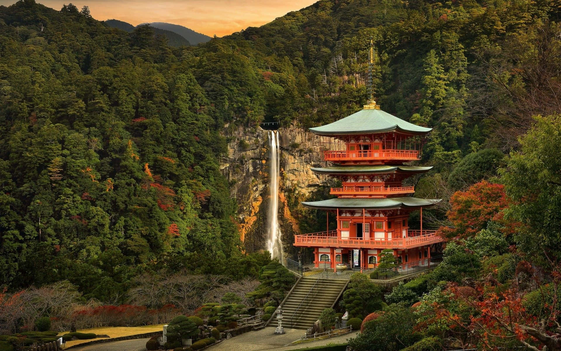 A Pagoda In The Forest With A Waterfall Background