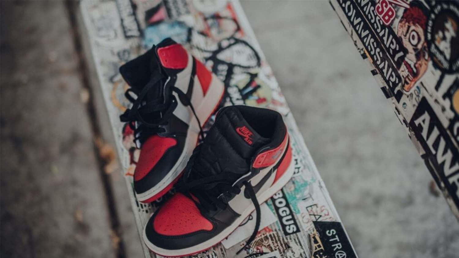 A Pair Of Air Jordan 1 High Sneakers On A Skateboard