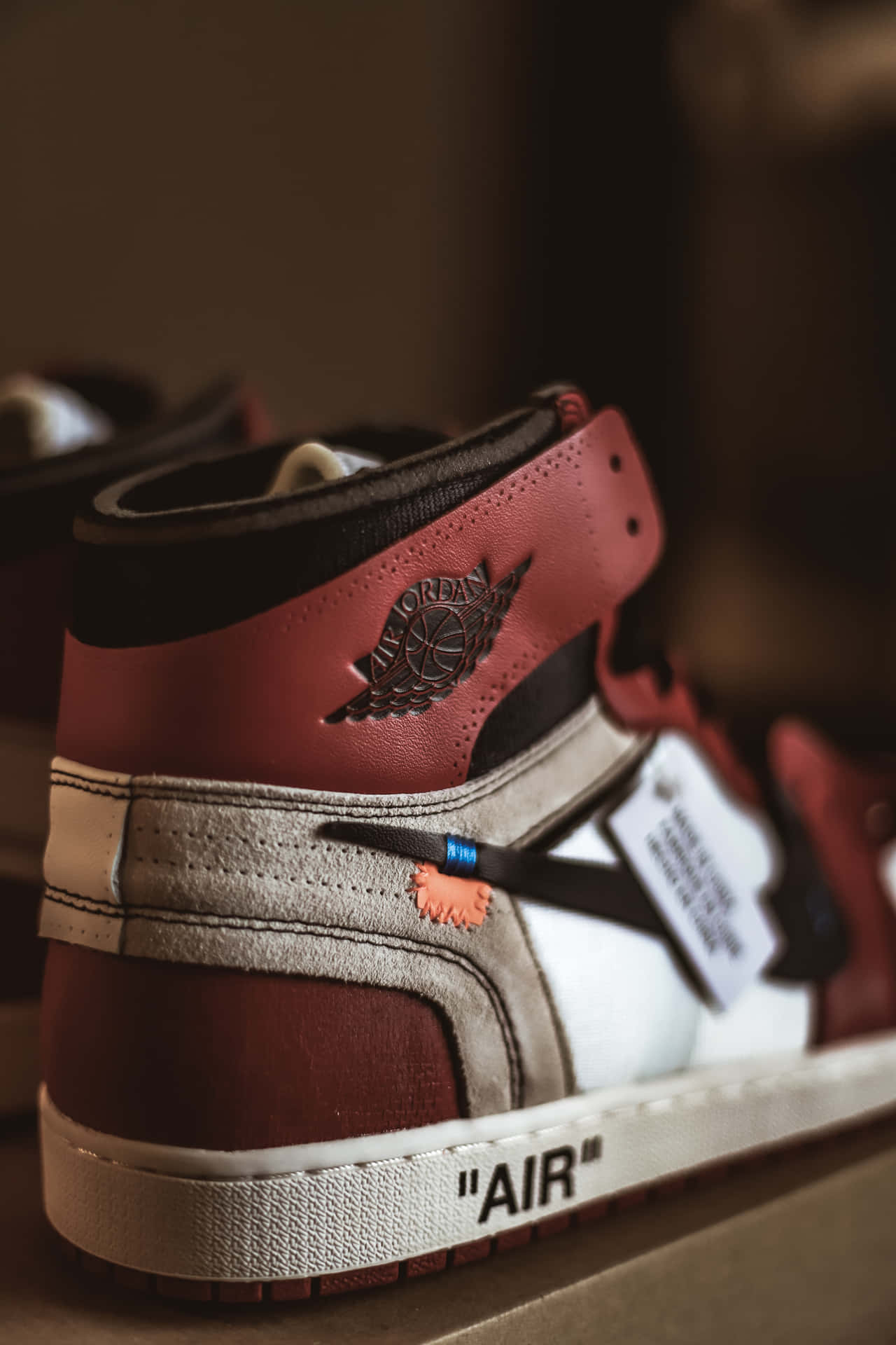 A Pair Of Air Jordan 1's With A Red And White Logo Background