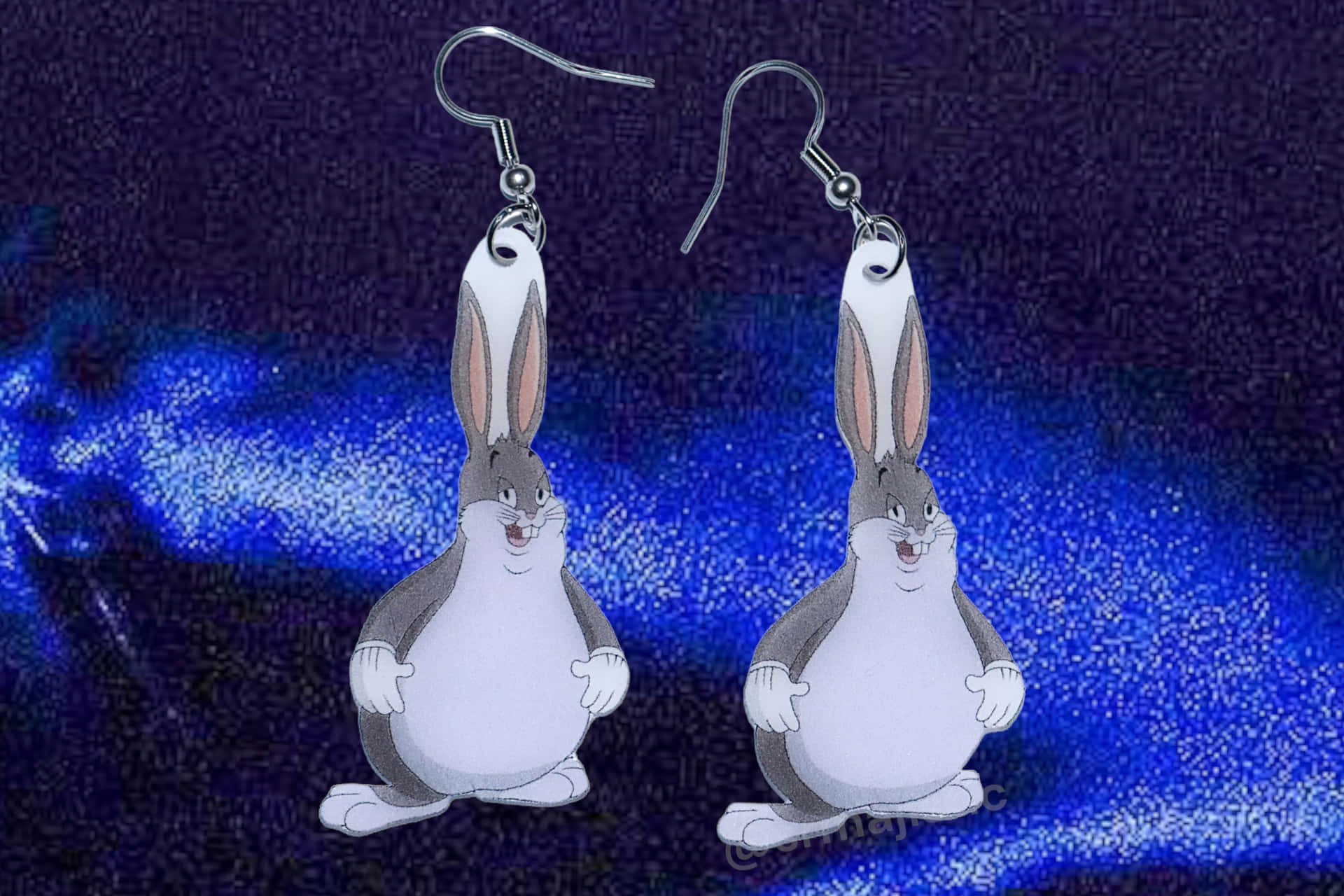 A Pair Of Cartoon Rabbit Earrings On A Blue Background Background