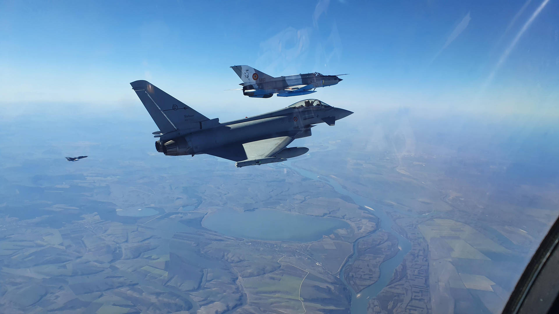 A Pair Of Fighter Jets Flying In The Sky