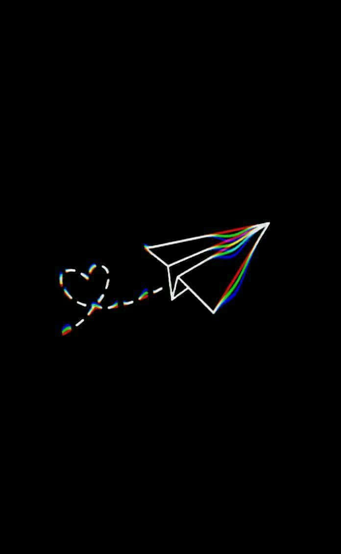 A Paper Airplane With A Rainbow String Background