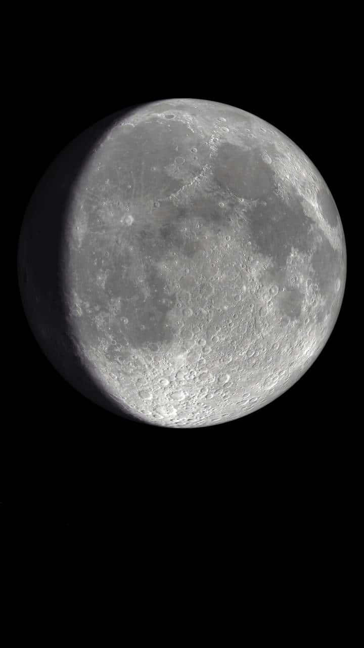 A Partial Moon Is Seen In The Sky Background