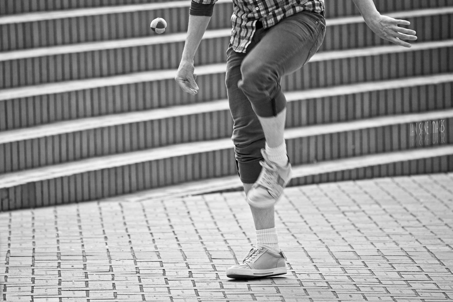 A Passionate Player Kicking Hacky Sack In Action