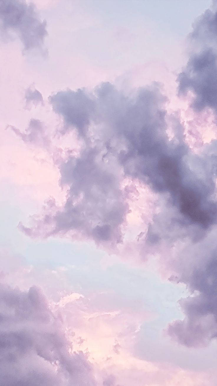 A Pastel Pink Iphone Resting Against A Silver And White Backdrop Background