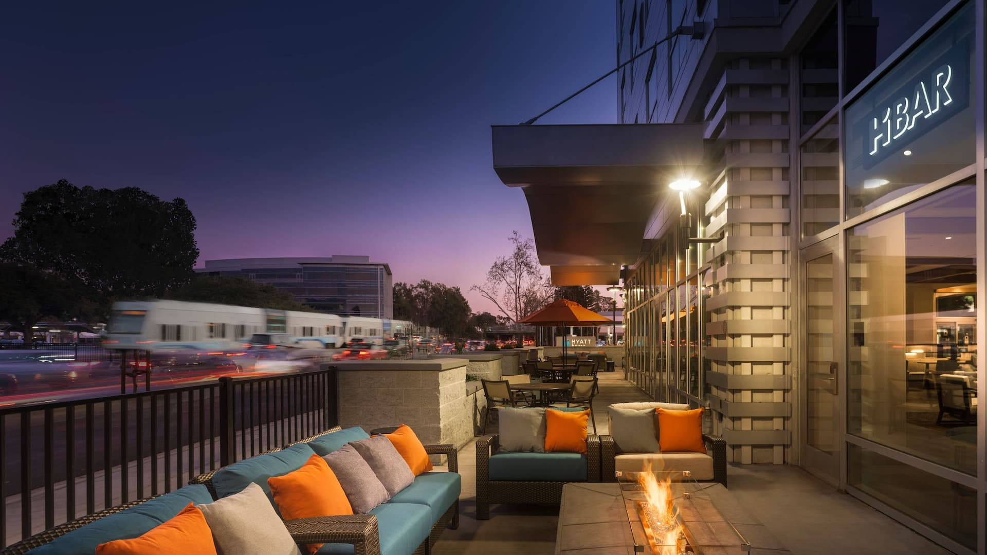 A Patio With Couches And Fire Pit At Dusk