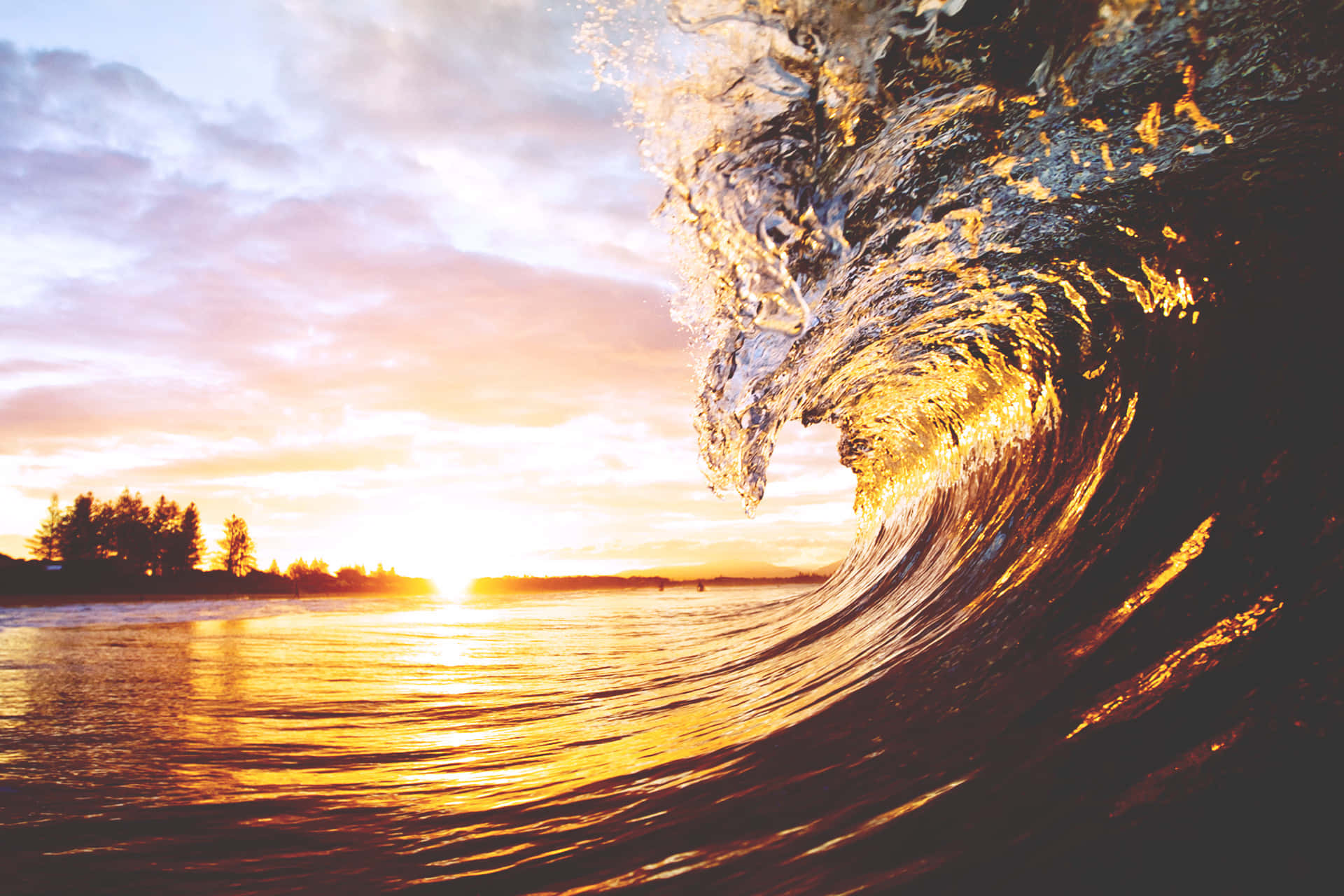 A Peaceful View Of The Setting Sun Reflected By A Wave Background