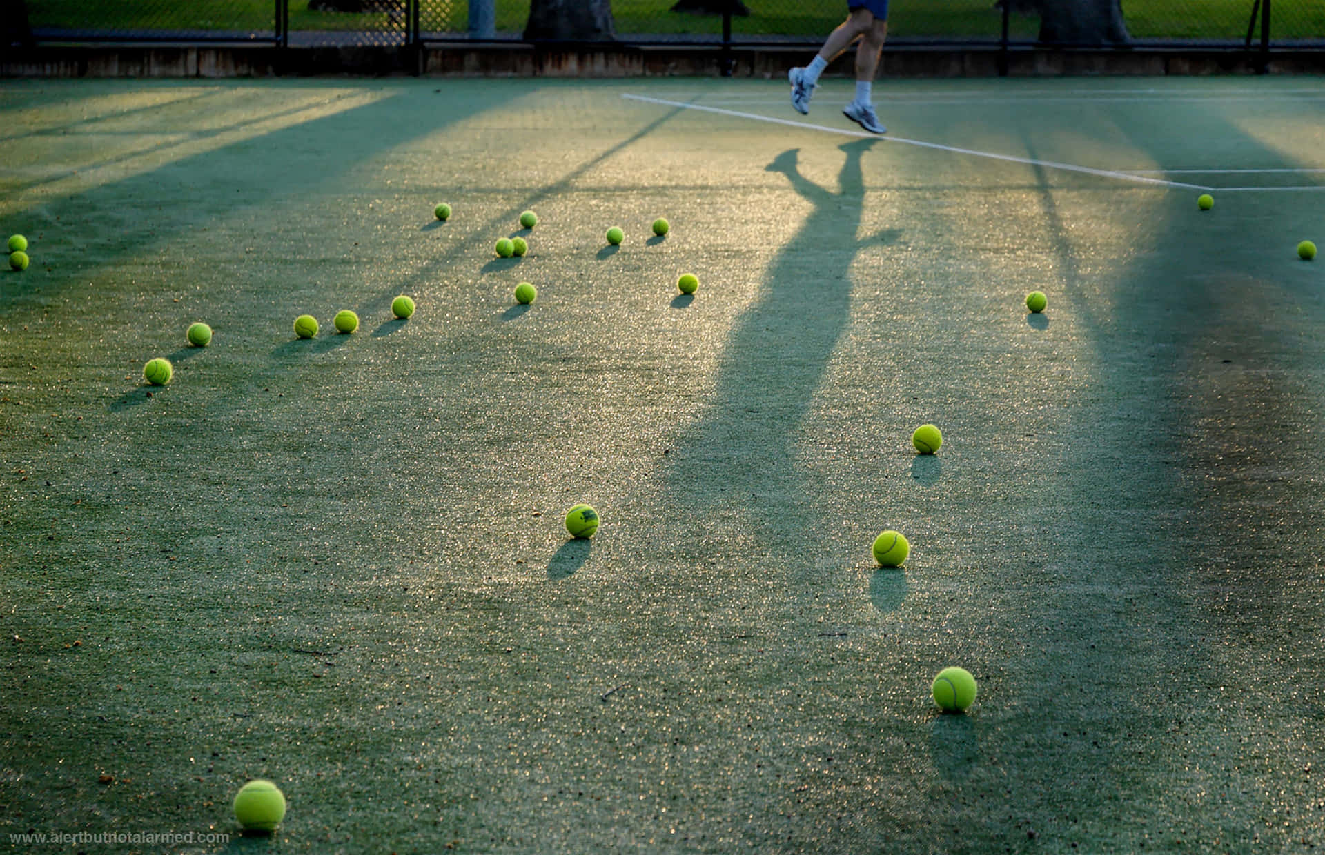 A Perfectly White Tennis Ball Bouncing On A Green Court