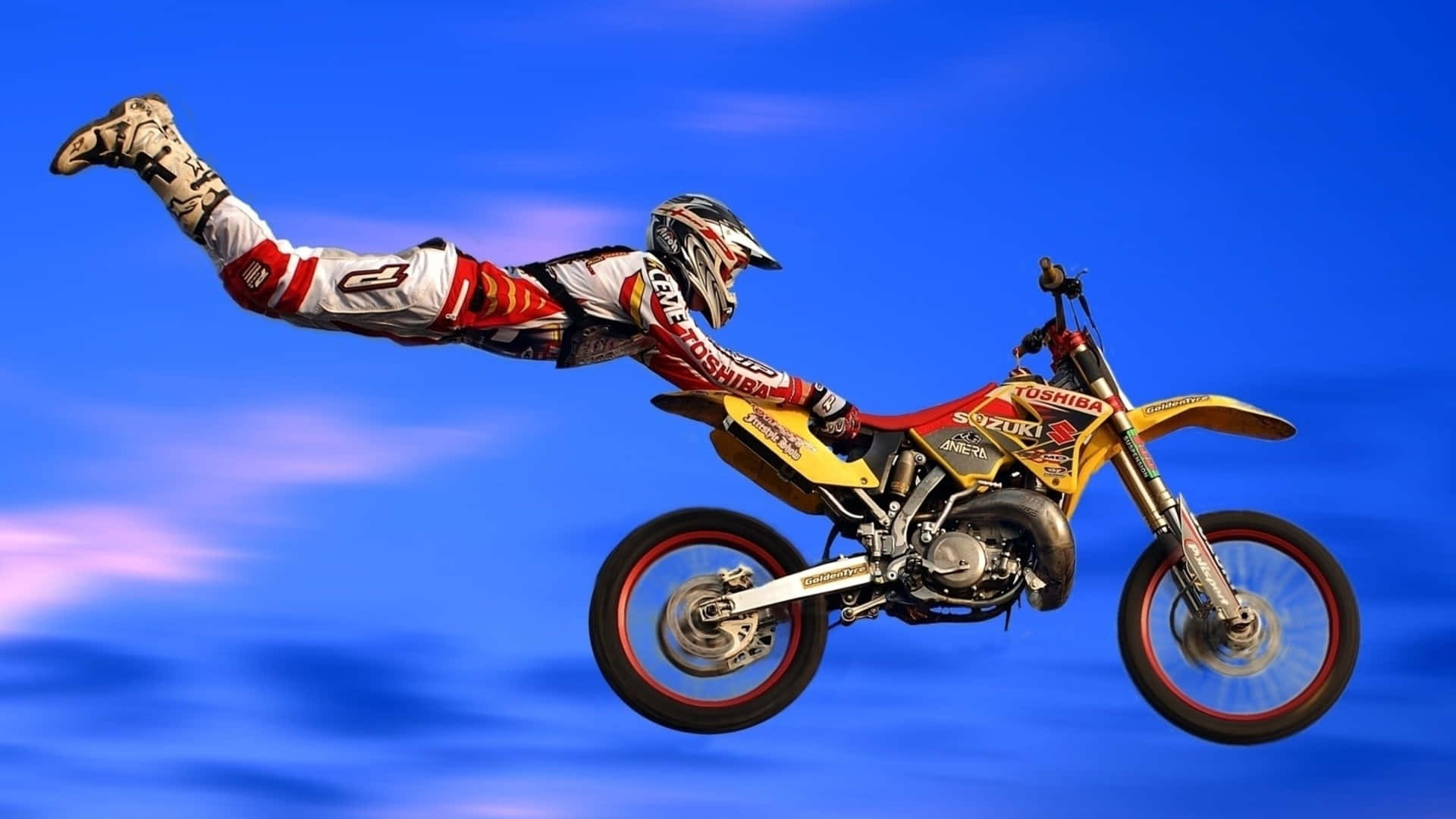 A Person Doing A Stunt On A Dirt Bike Background