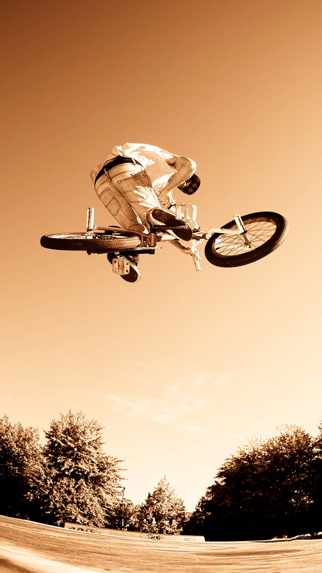 A Person Doing A Trick On A Bike Background