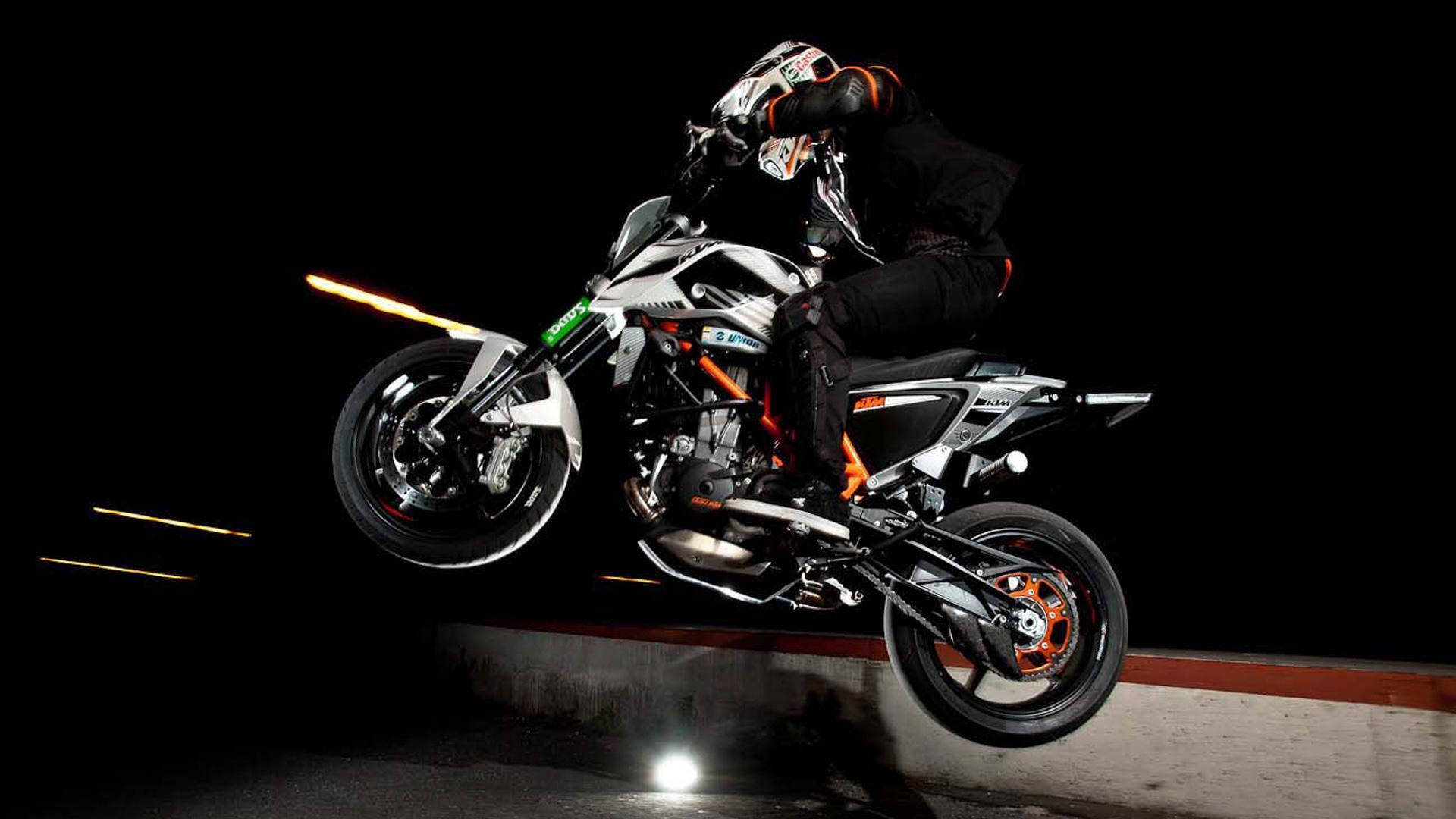 A Person Doing A Trick On A Motorcycle Background