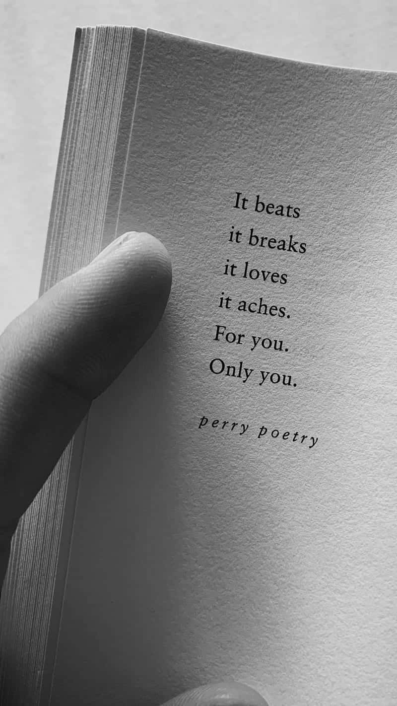 A Person Holding A Book With The Words If Beats It Breaks It Loves You Only You Background