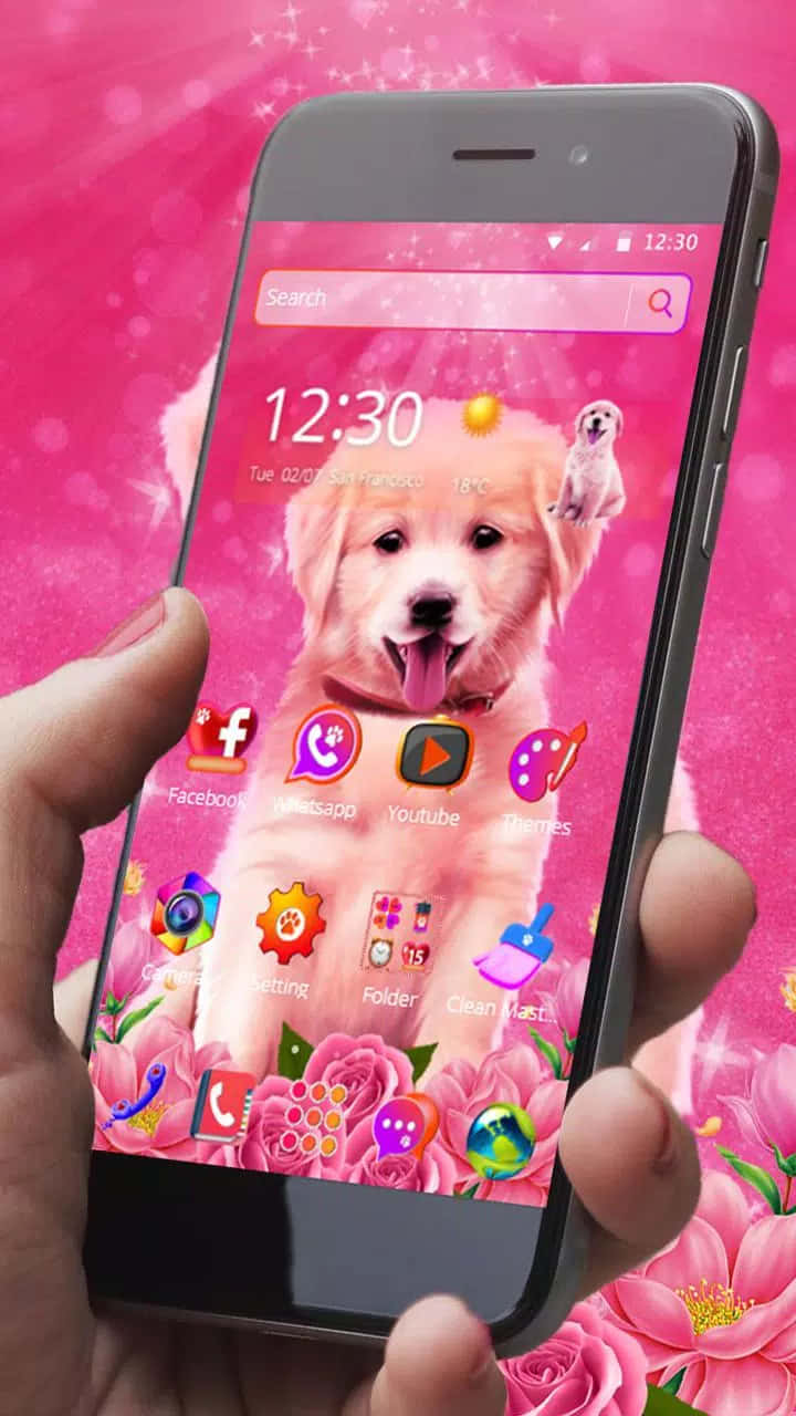 A Person Holding A Pink Phone With A Puppy On It