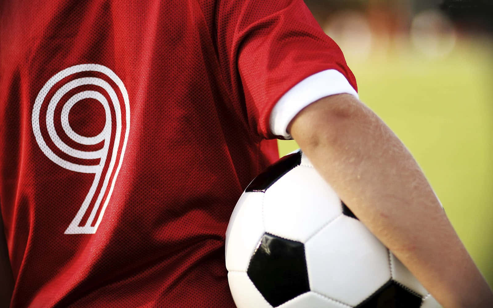A Person Holding A Soccer Ball Background