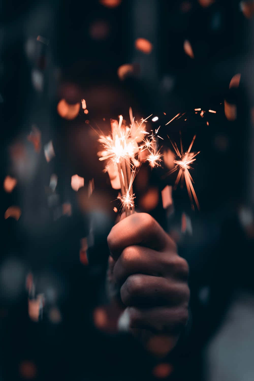 A Person Holding A Sparkler In Their Hand