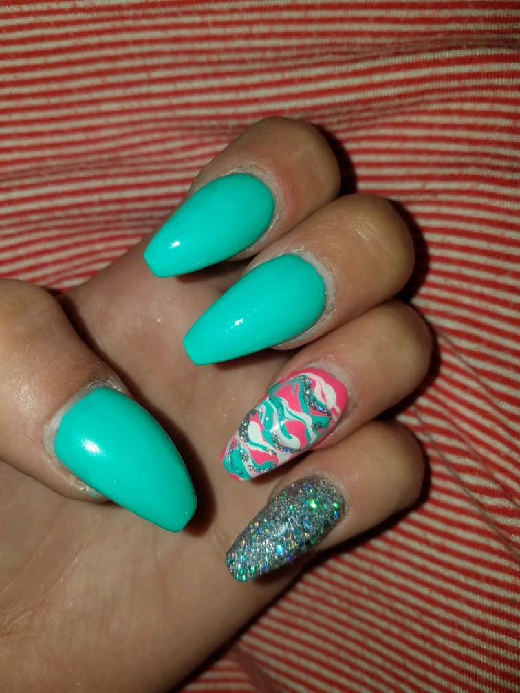 A Person Holding Up A Green And Silver Nail With A Glitter Design Background