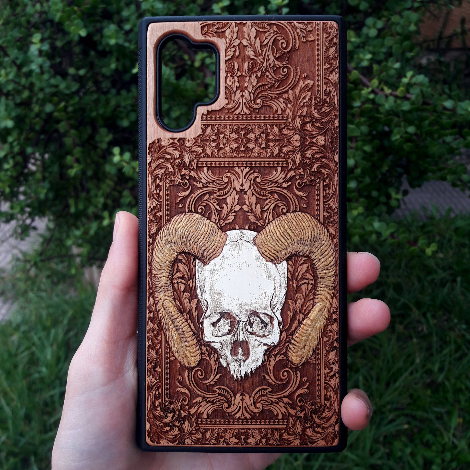 A Person Holding Up A Samsung Galaxy Note 10 Case With A Skull On It