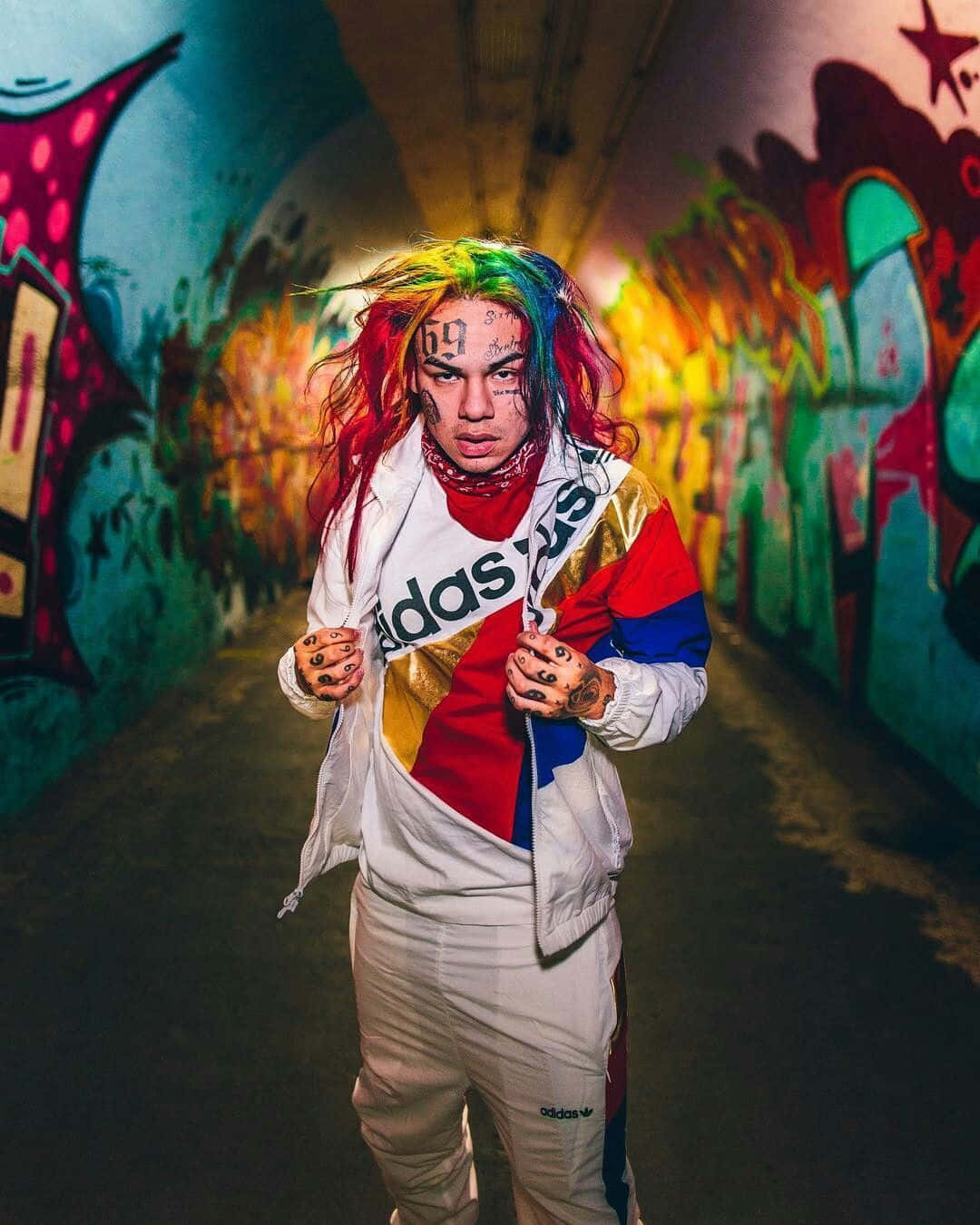 A Person In A Colorful Outfit Standing In A Tunnel Background