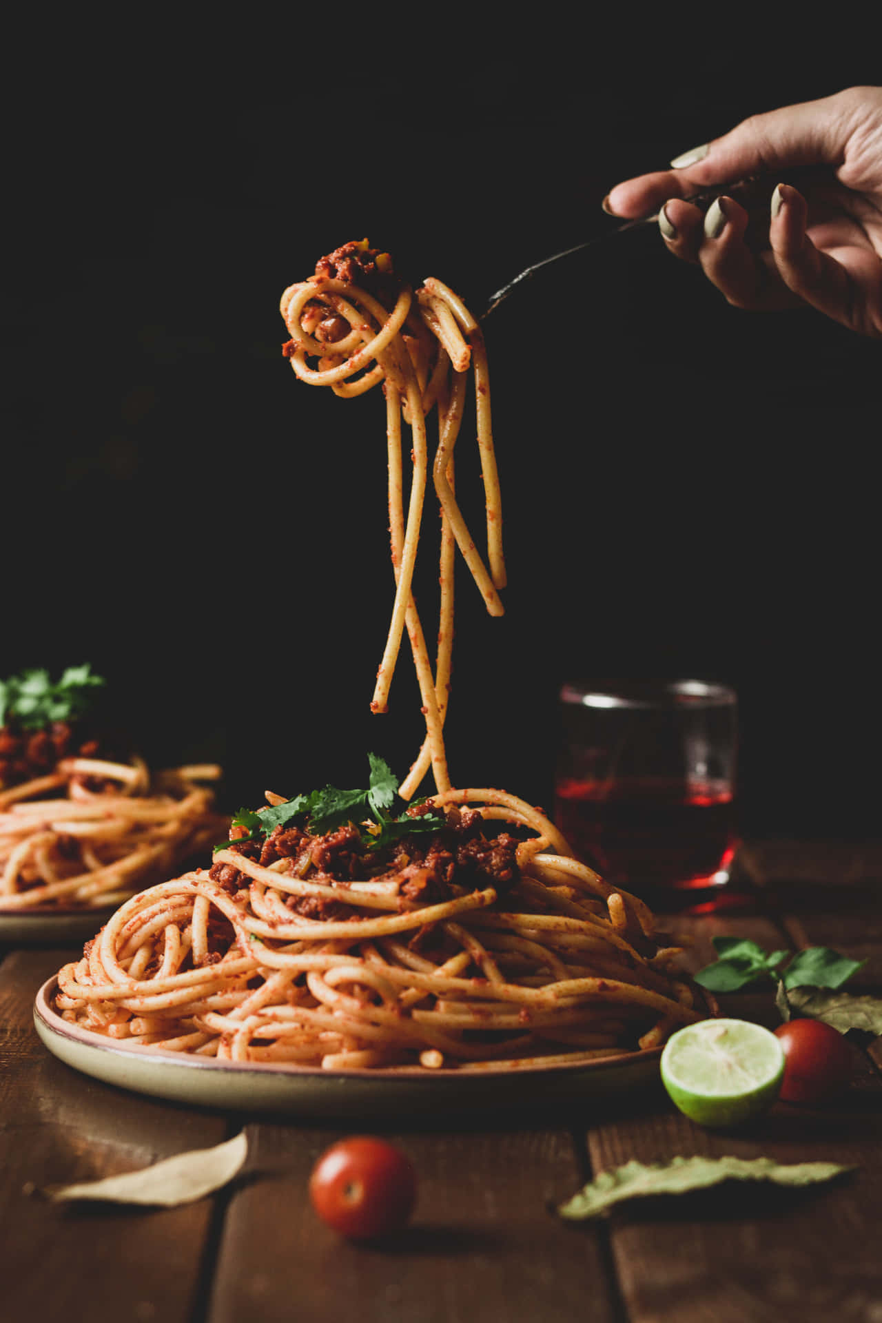 A Person Is Holding Spaghetti On A Plate Background
