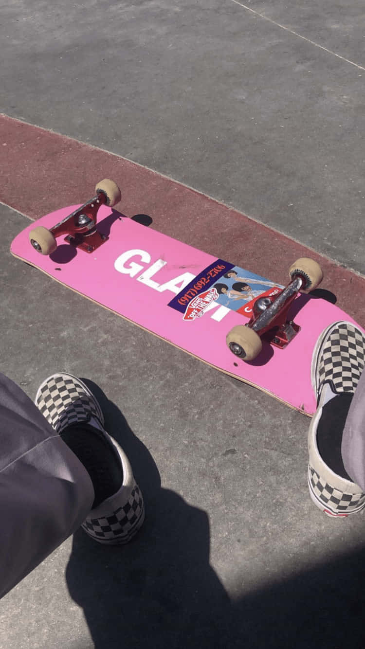 A Person Is Sitting On A Skateboard Background