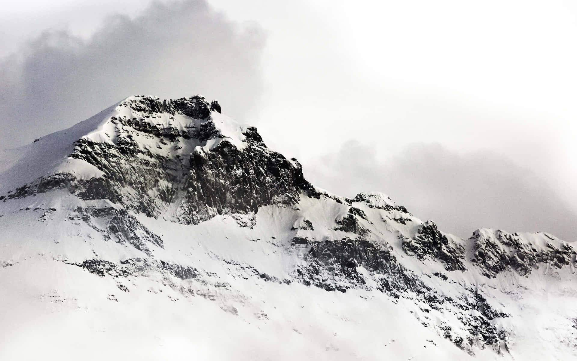 A Person Is Skiing Down A Snow Covered Mountain Background