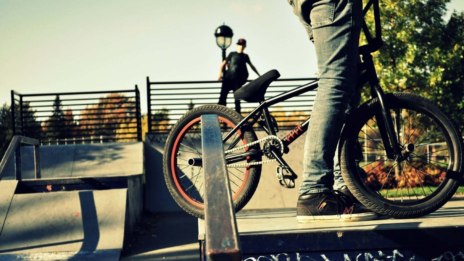 A Person Riding A Bike On A Ramp Background