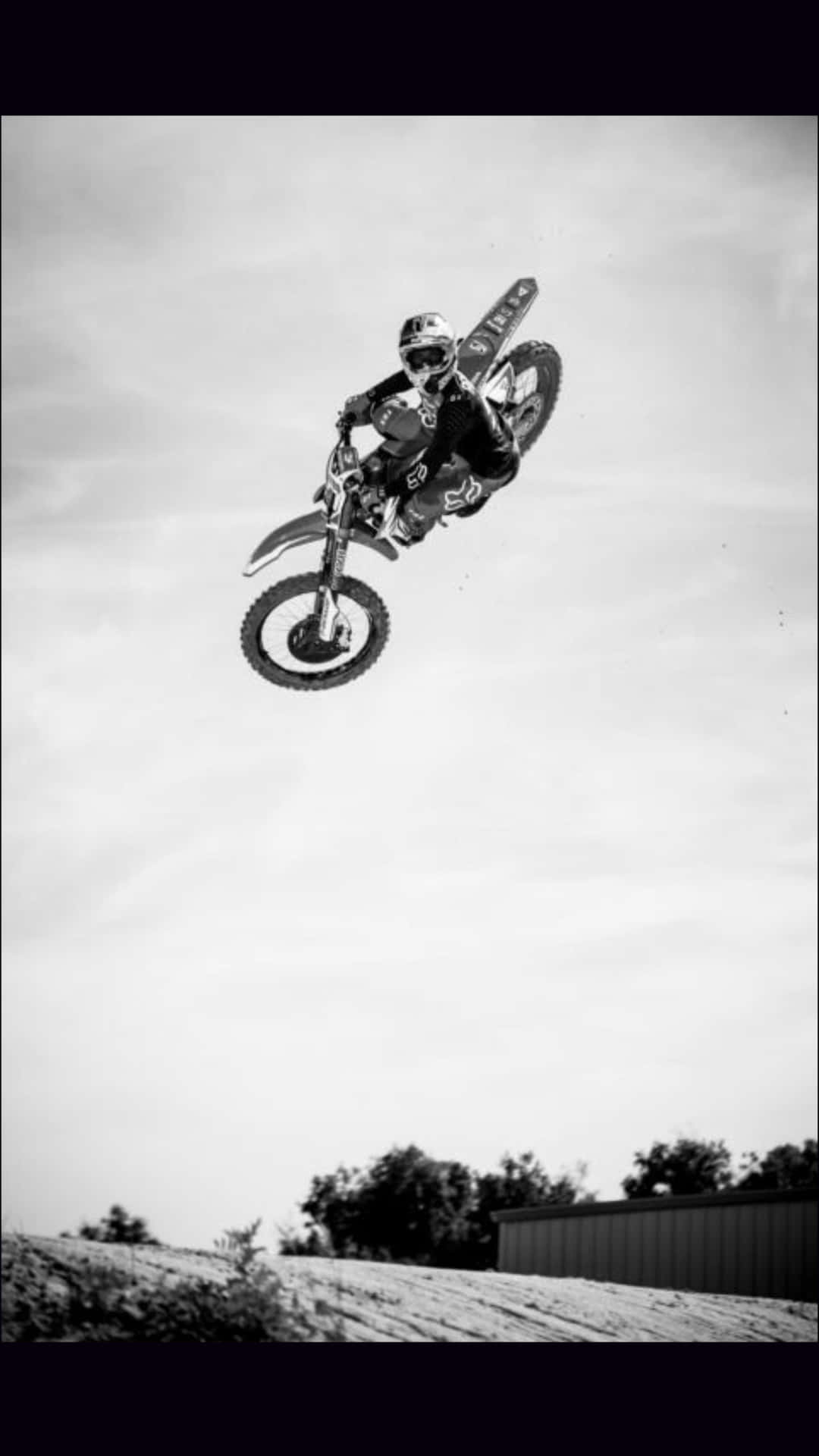 A Person Riding A Dirt Bike In The Air