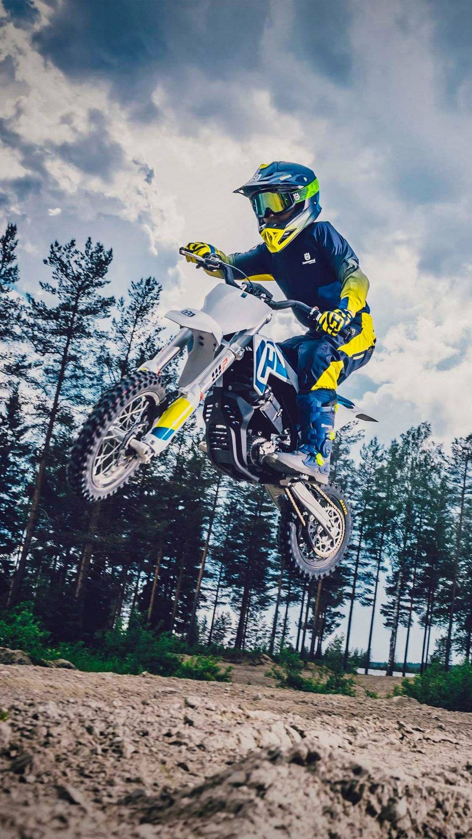 A Person Riding A Dirt Bike In The Air Background